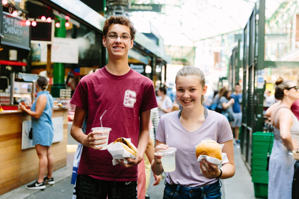 students enjoy lunch at Borough Market on an educational trip in London